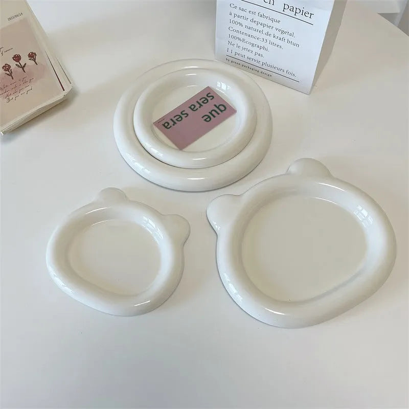 White ceramic plate with chubby bear or round toot design, shown in 15cm and 20cm sizes as a plant tray.
