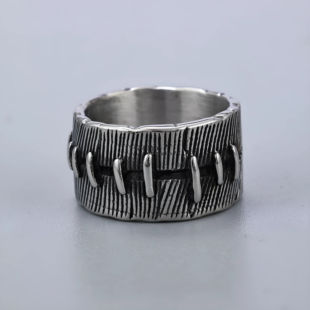 Geometric titanium steel double ring in a dark punk style with a U-shape and stitched design.