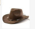 Brown leather velvet Western cowboy hat with curved edge and conical crown on wooden surface