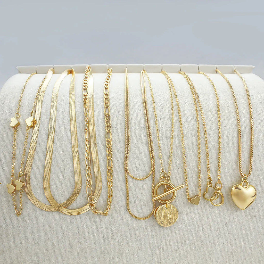 Ten-piece gold women's necklace set with adjustable snake bone chains and alloy pendants