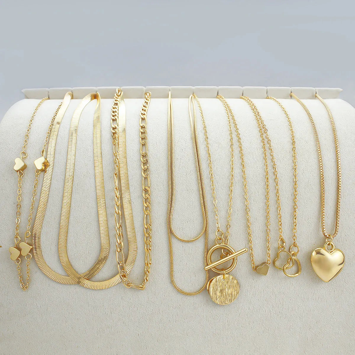 Ten-piece gold women's necklace set with adjustable snake bone chains and alloy pendants
