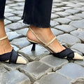 Apricot and black colour block women's sandals with a stiletto heel and buckle fastening.