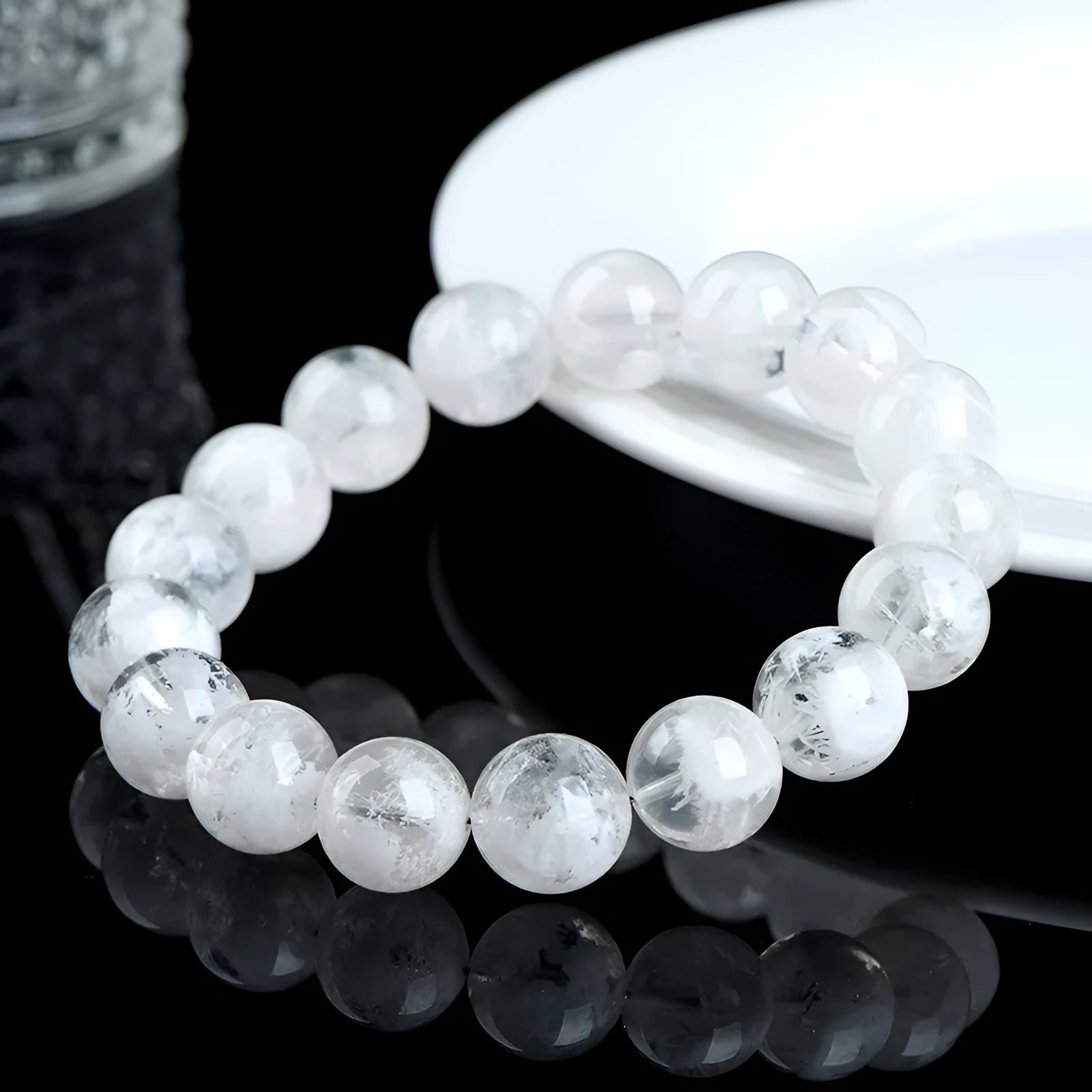 Close-up of a women's bracelet with round geometric crystal beads in a natural blizzard snowflake finish, showing Ruyi and Xiangyun design details.