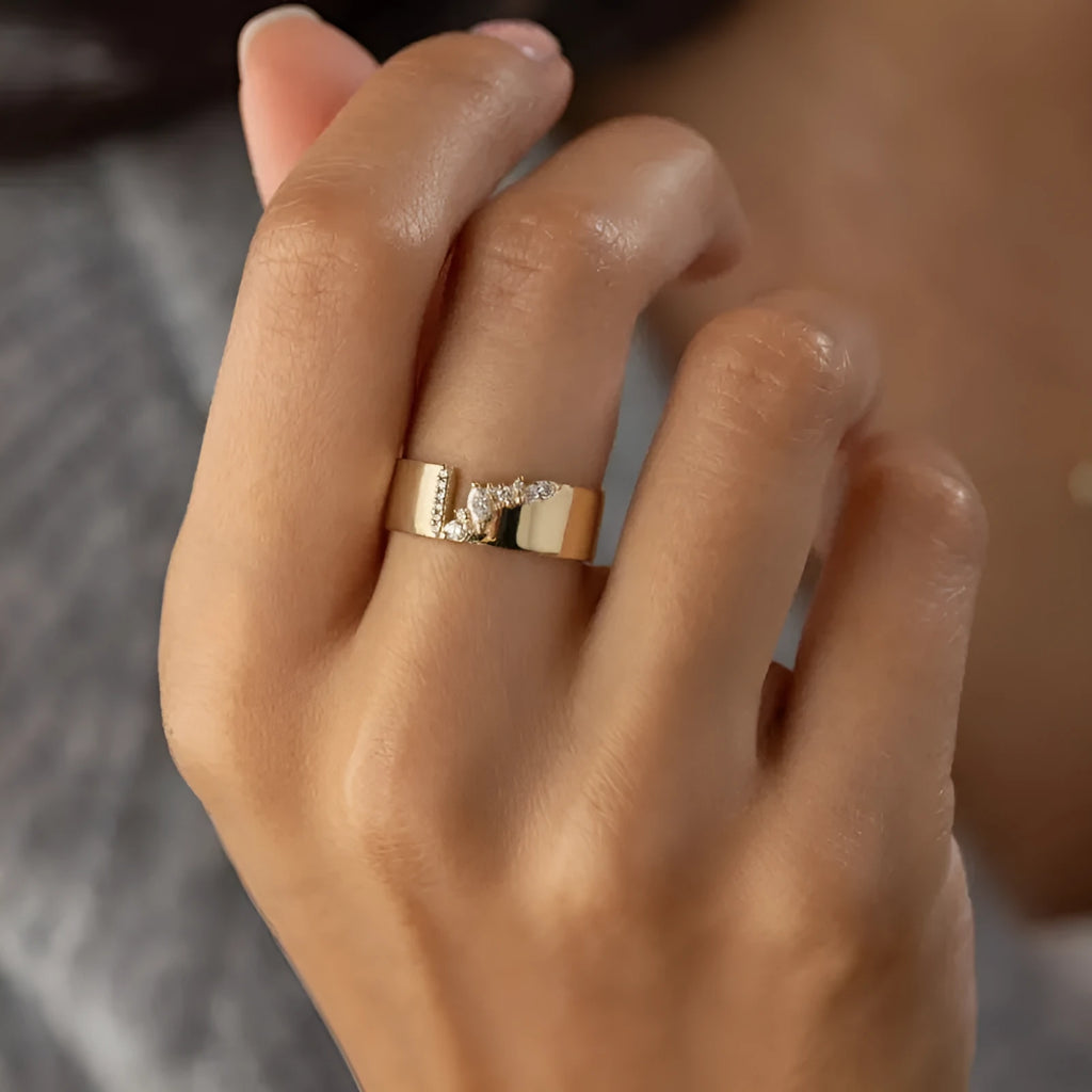 Gold plated copper ring for women with shining zircon detail on a finger.