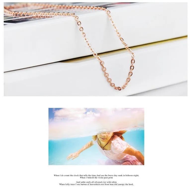 Rose gold necklace with heart-shaped pink crystal pendant and cross chain design
