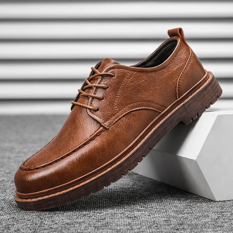 Men's black and brown casual leather slip-on shoes with round toe and visible sewing line detailing.