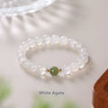 Handmade white agate and crystal bracelet with cinnabar inlay showing letter modelling on 8mm beads.