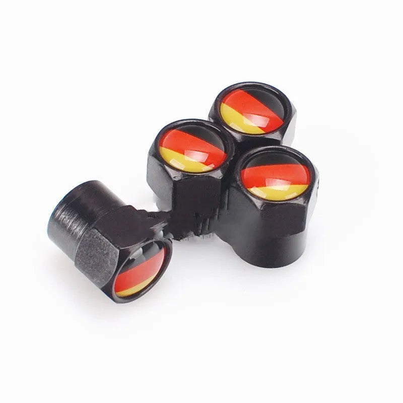 Set of four black metal aluminium alloy valve caps with German flag design on white background