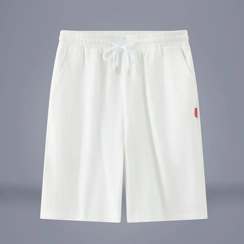 A pair of solid colour cotton linen cropped pants with a drawstring waist, shown in Army Green.
