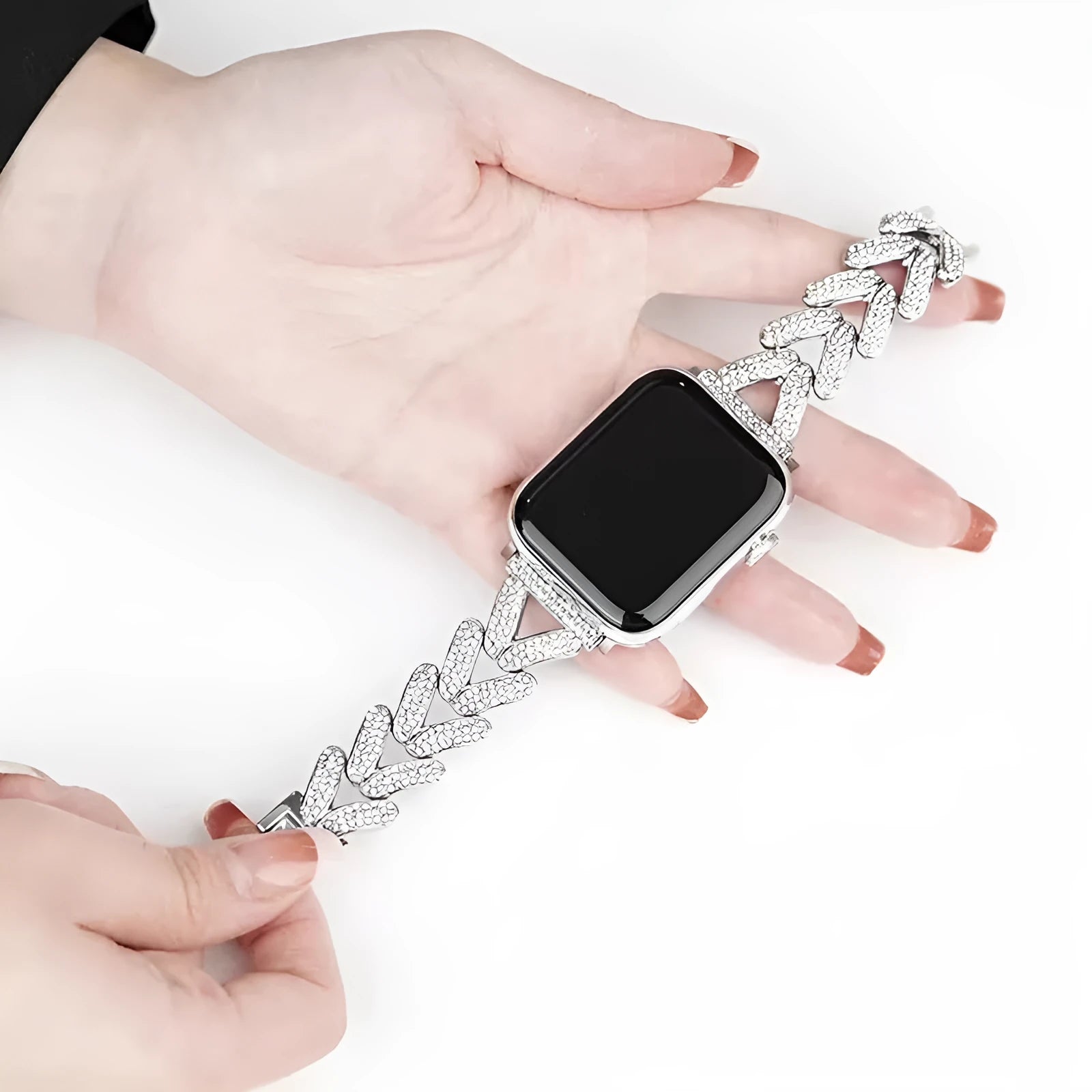 Silver metal Apple Watch strap with V-shaped diamond-embedded detailing