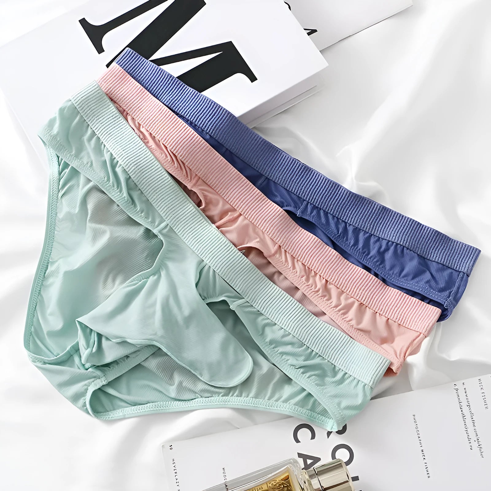 Men's low waist briefs underwear in ice silk fabric, shown in multiple colours.
