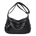 Large blue PU leather crossbody bag for women showing horizontal square shape and internal organiser pockets.