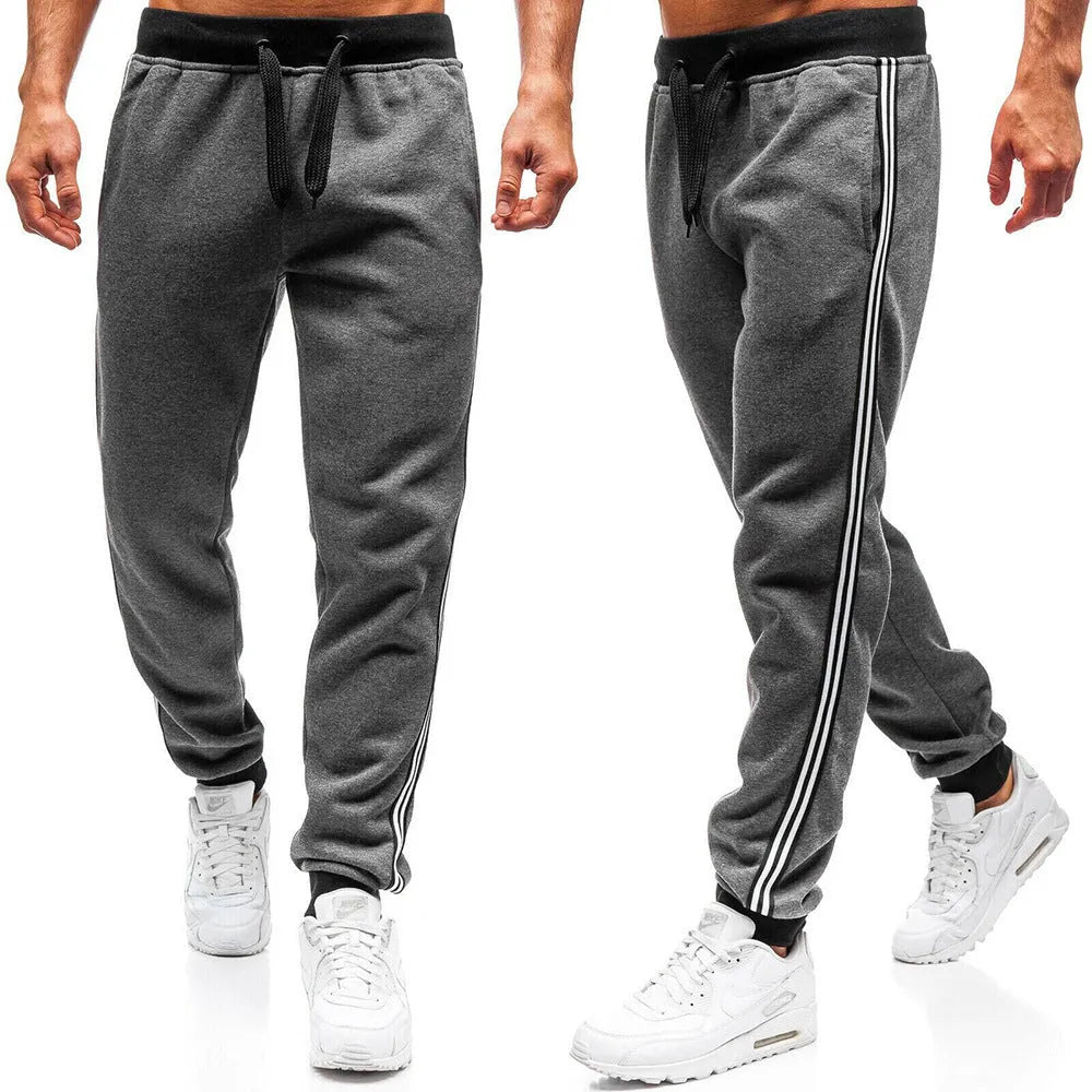 Men's summer casual loose tapered sports trousers in black with elastic waist, drawstring, and stitching details
