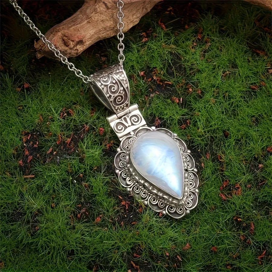 Silver heart-shaped moonstone drop necklace on a white background