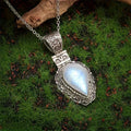 Silver heart-shaped moonstone drop necklace on a white background
