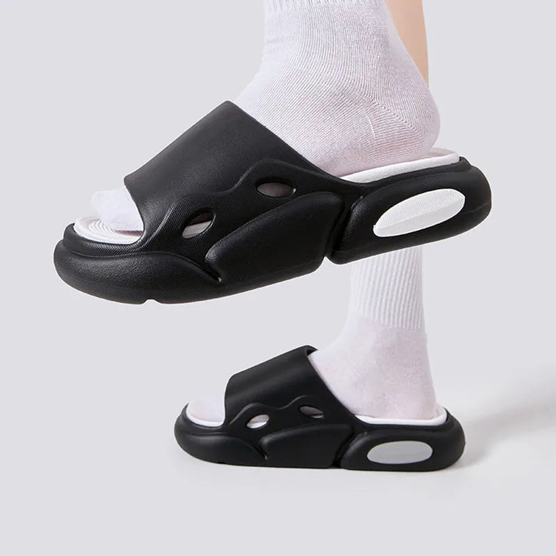 A pair of unisex EVA foam slippers with a thick sole and leather lining, shown in a two-colour design.