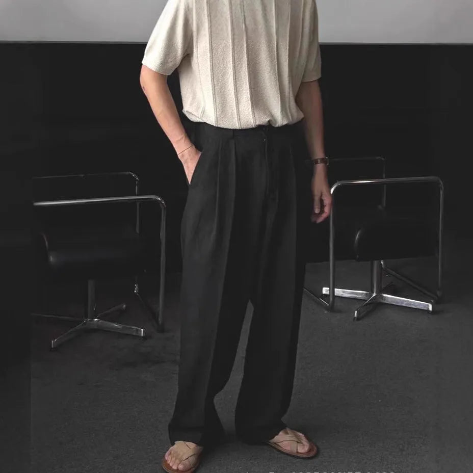 Men's loose-fit apricot cotton linen trousers with wide-leg Korean style on a neutral background.