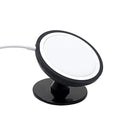 Black car magnetic mobile phone holder mounted on vehicle dashboard