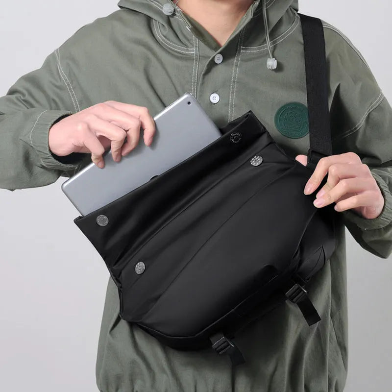 Grey men's crossbody sling backpack with zipper opening and shoulder strap