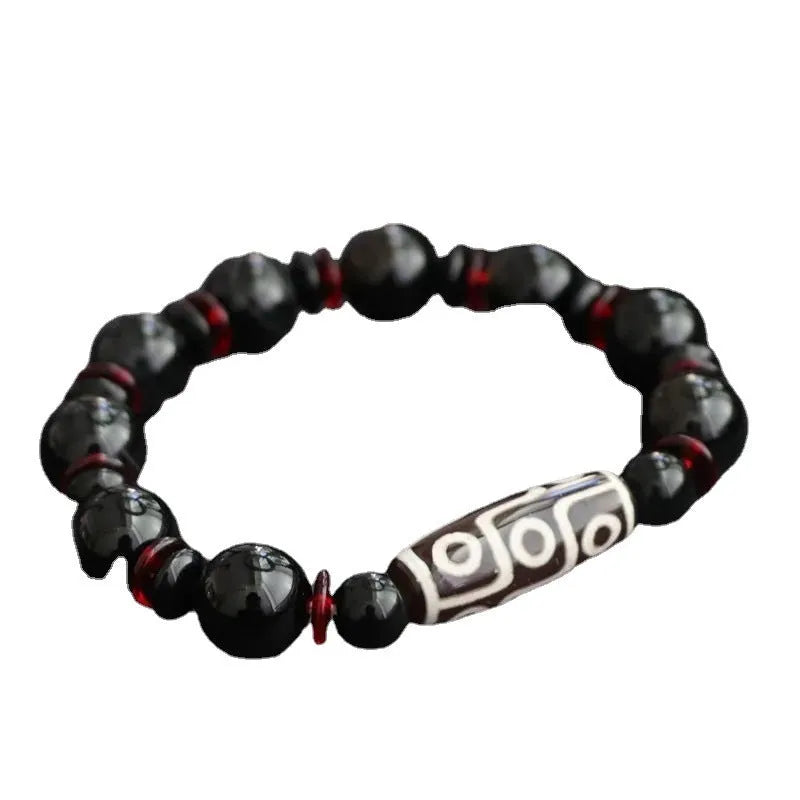 Hand-woven black agate dzi bead bracelet with geometric design measuring 11mm diameter