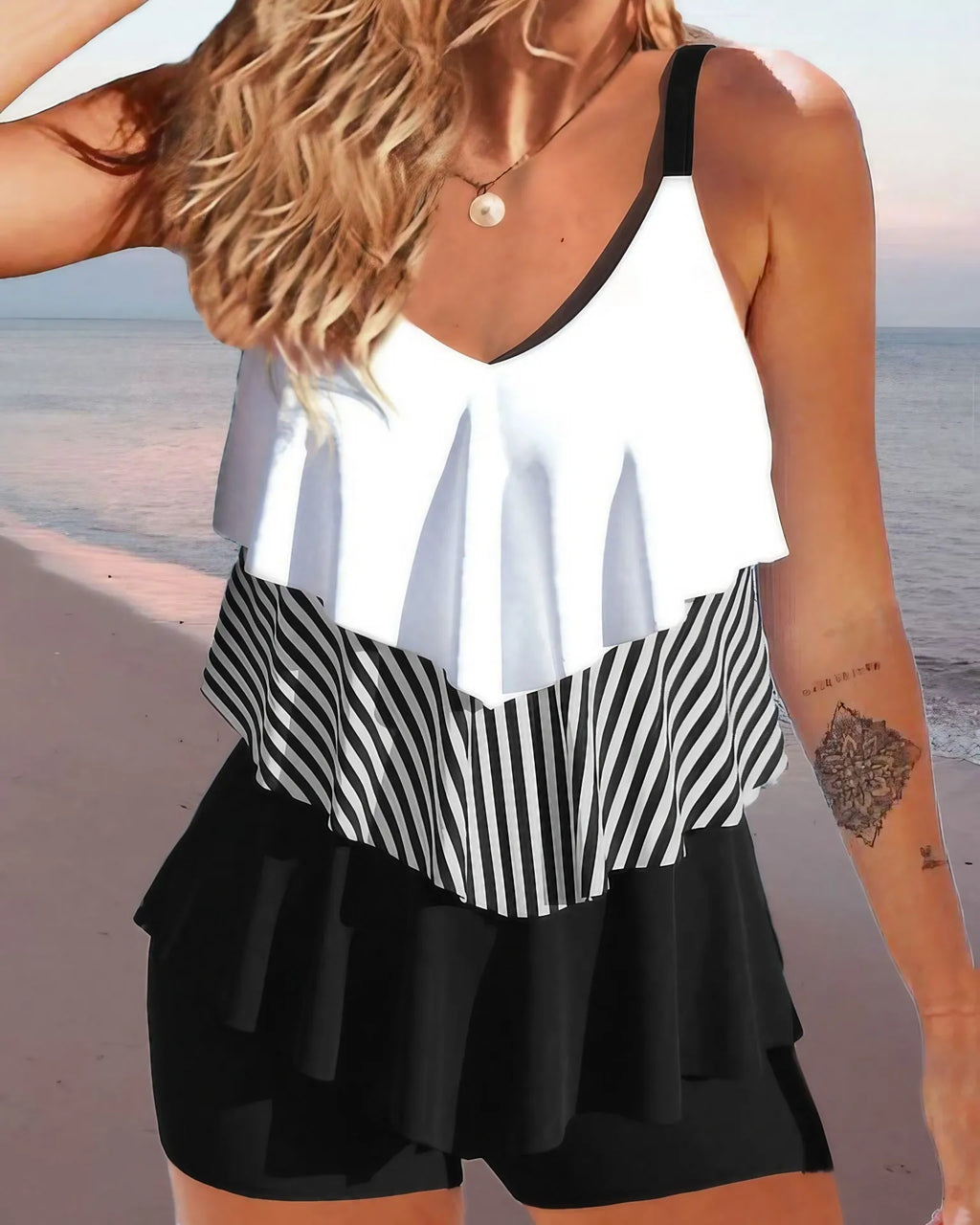 Women's backless bikini swimsuit with spaghetti straps and a ruffle trim.