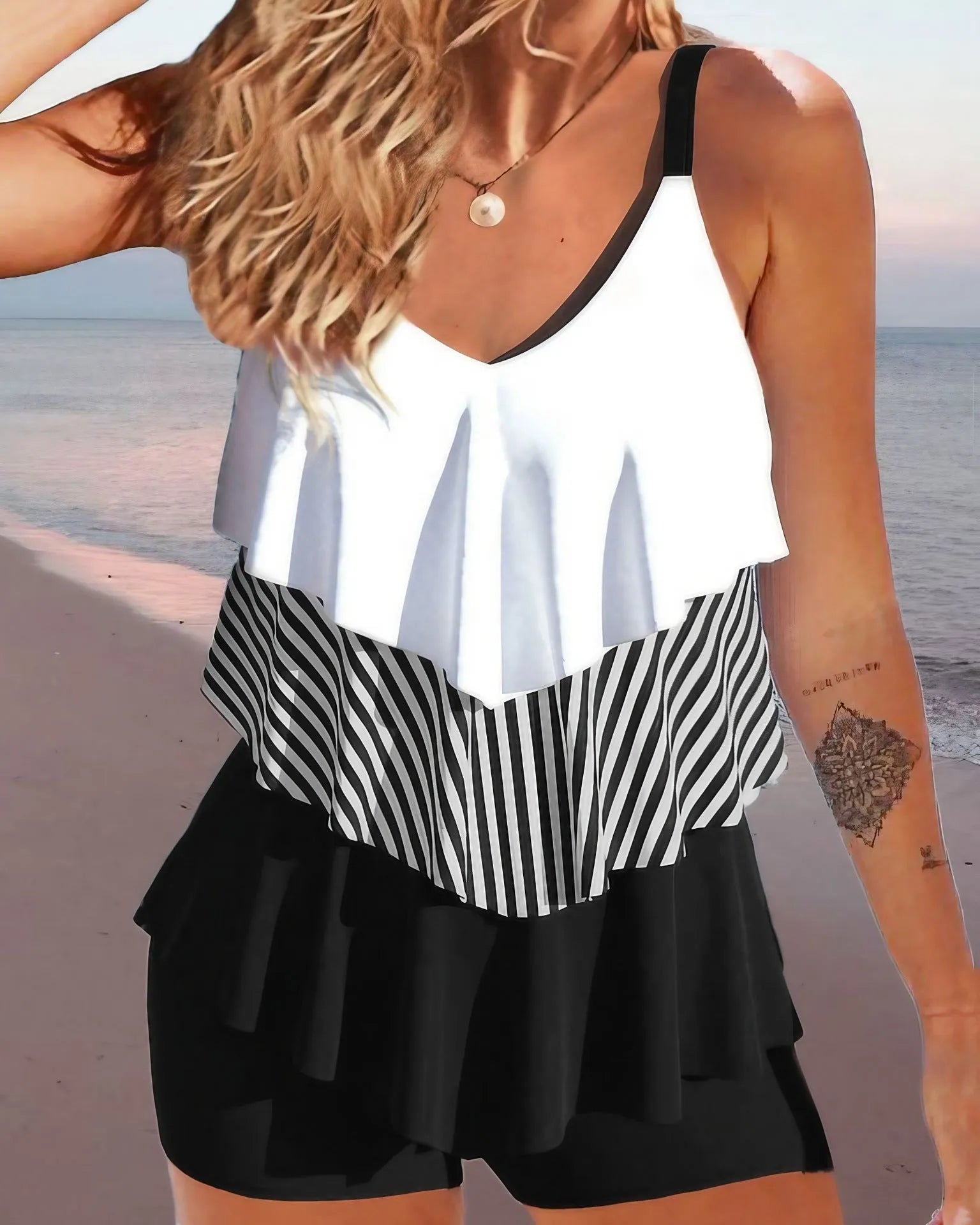 Women's backless bikini swimsuit with spaghetti straps and a ruffle trim.