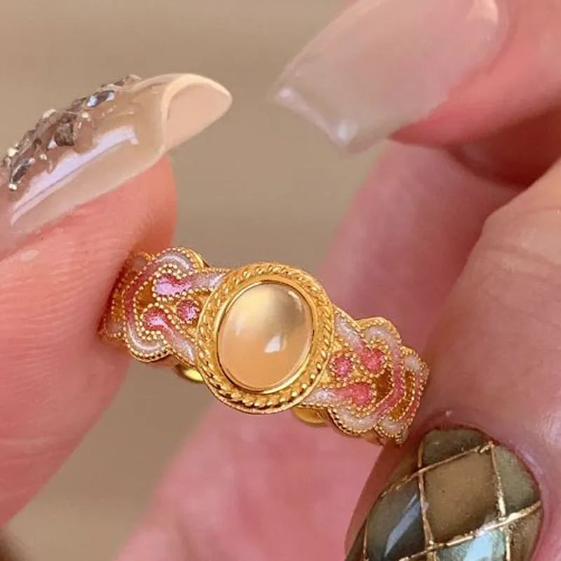 Pink crystal enamel geometric open ring on gold-plated copper band for women.
