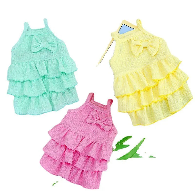 Small dog wearing princess dress with candy-layered skirt in rose red, yellow, or water green colour