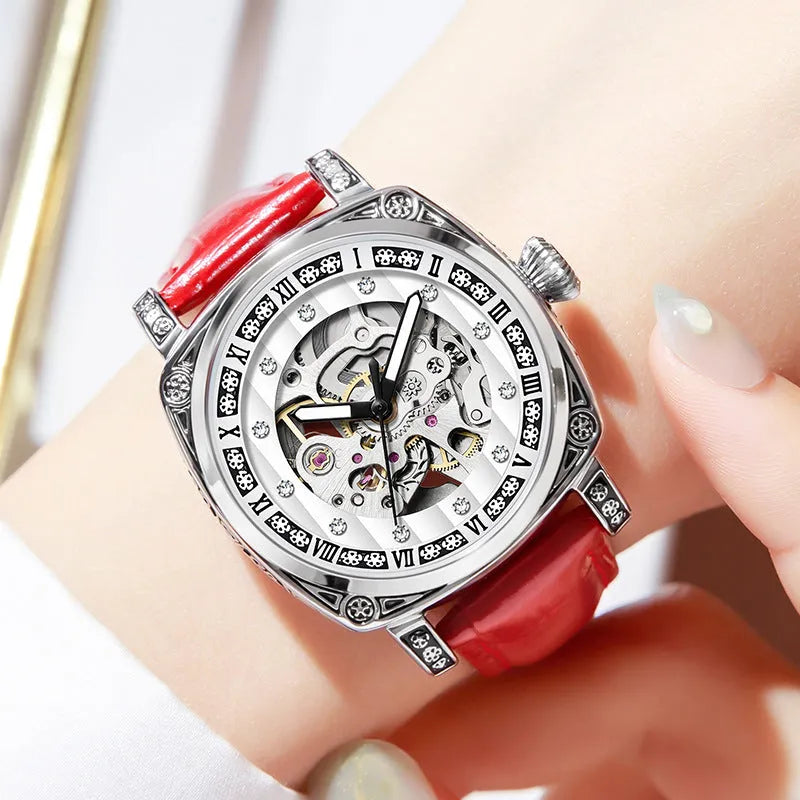 Mechanical watch with luminous hands on a leather strap, shown in black, red, steel, and white colour options.