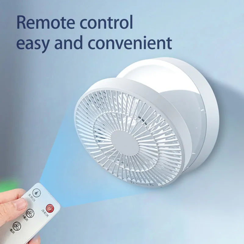 White portable folding fan with remote control on wooden desktop next to USB charging cable