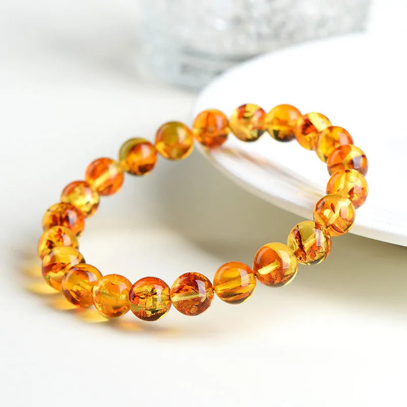 A geometric bead bracelet made from natural yellow piebald amber with flower spot patterning.