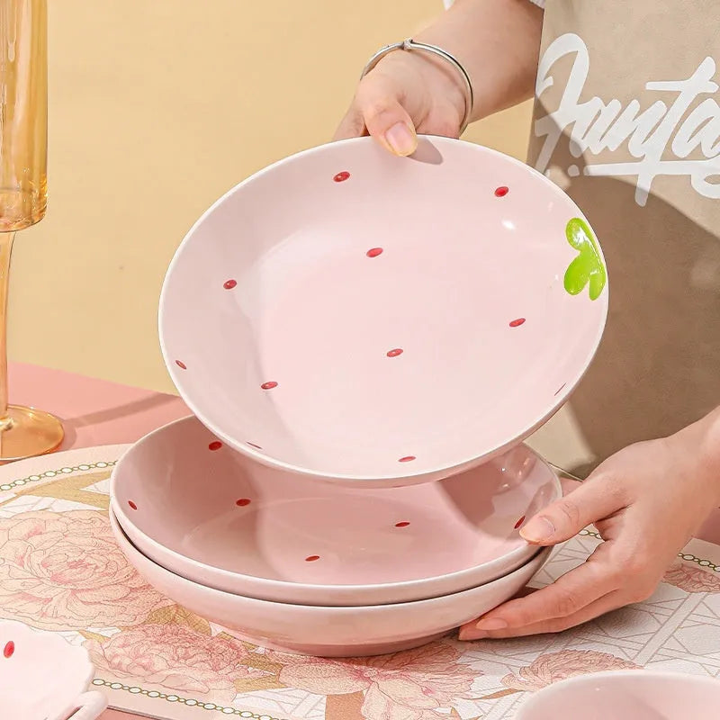 Cute strawberry-themed porcelain dinnerware set with flower bowl, straw hat plate, disc, and twist spoon.