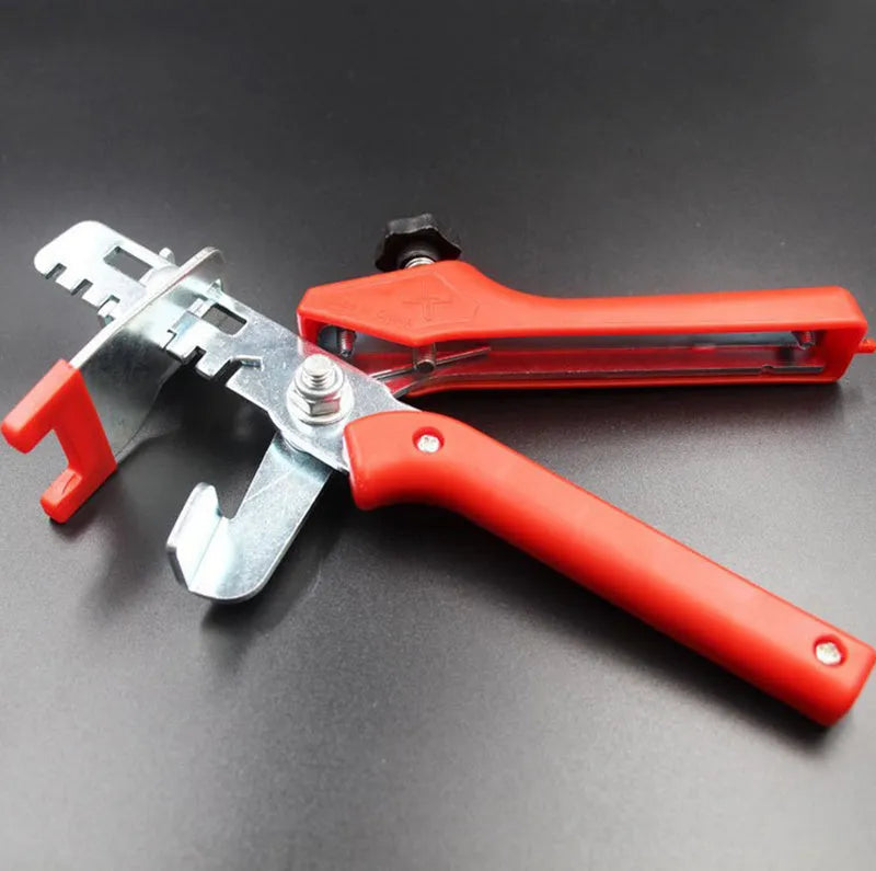 Red tile leveler aid with PVC handle and stainless steel clip measuring 23 by 11.5 centimetres