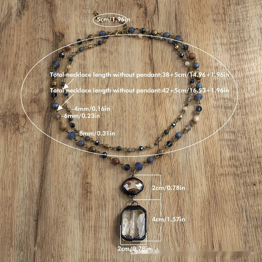 Tribal-style retro necklace with a blue stone and glass pendant on a metal chain.