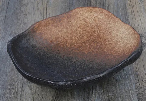 Irregular shaped Japanese coarse pottery bowl with floral decoration measuring 24cm length