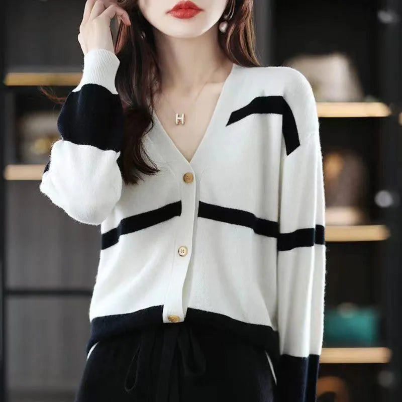 Women's black and white striped V-neck knitted cardigan with 3D pattern and buttons.