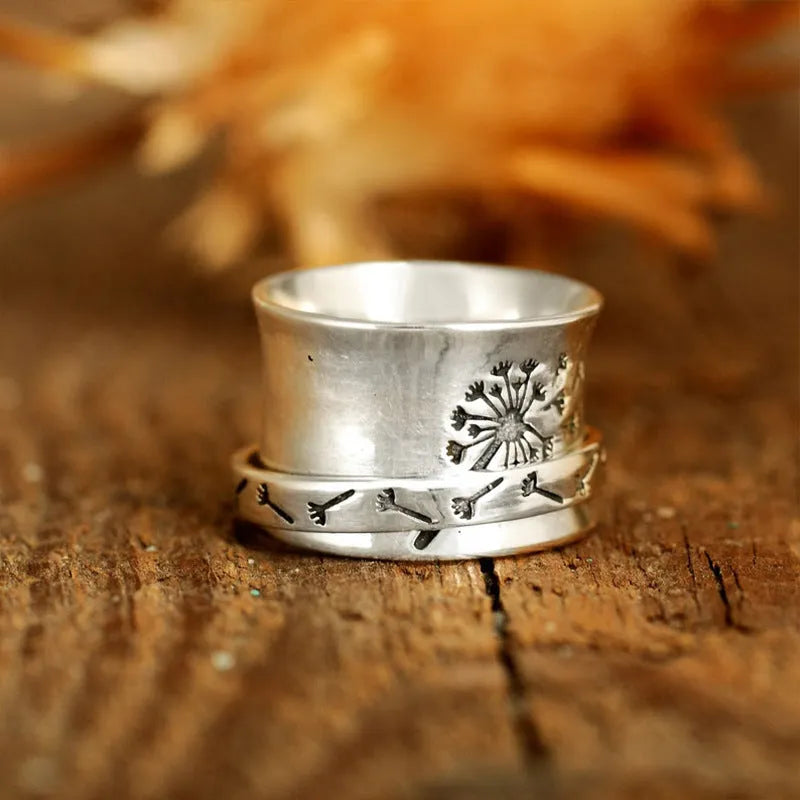 Silver-colour rotating flower ring showing floral element that moves independently of band