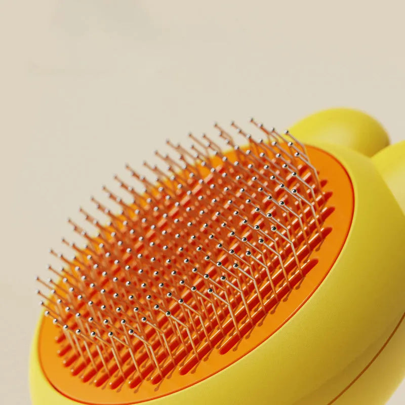 Green self-cleaning pet grooming brush with stainless steel teeth and rubber tips