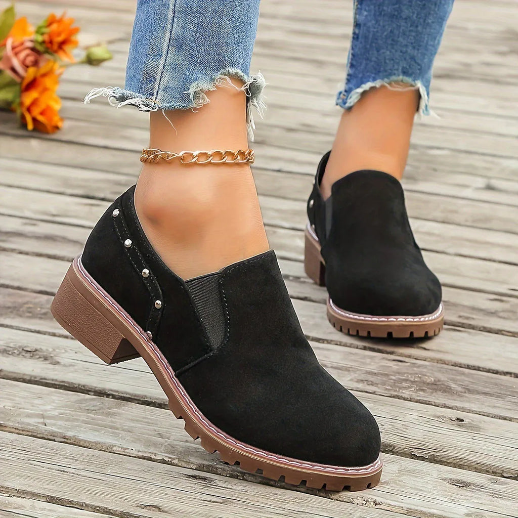 Women's light brown suede ankle boots with a low thick heel and elastic band fastening.