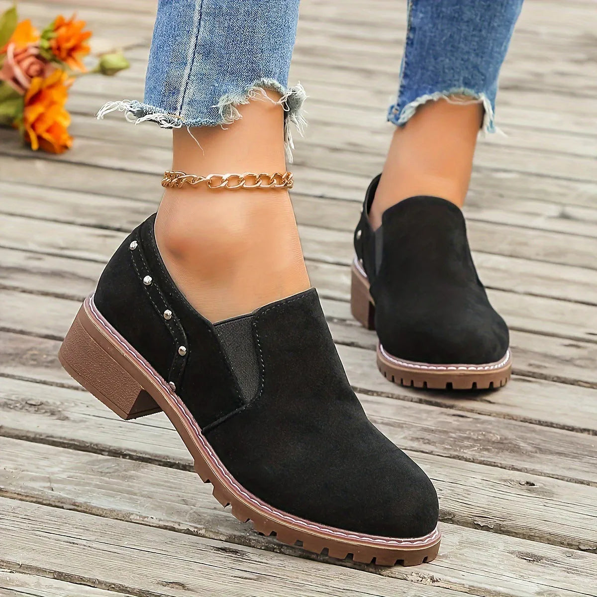 Women's light brown suede ankle boots with a low thick heel and elastic band fastening.