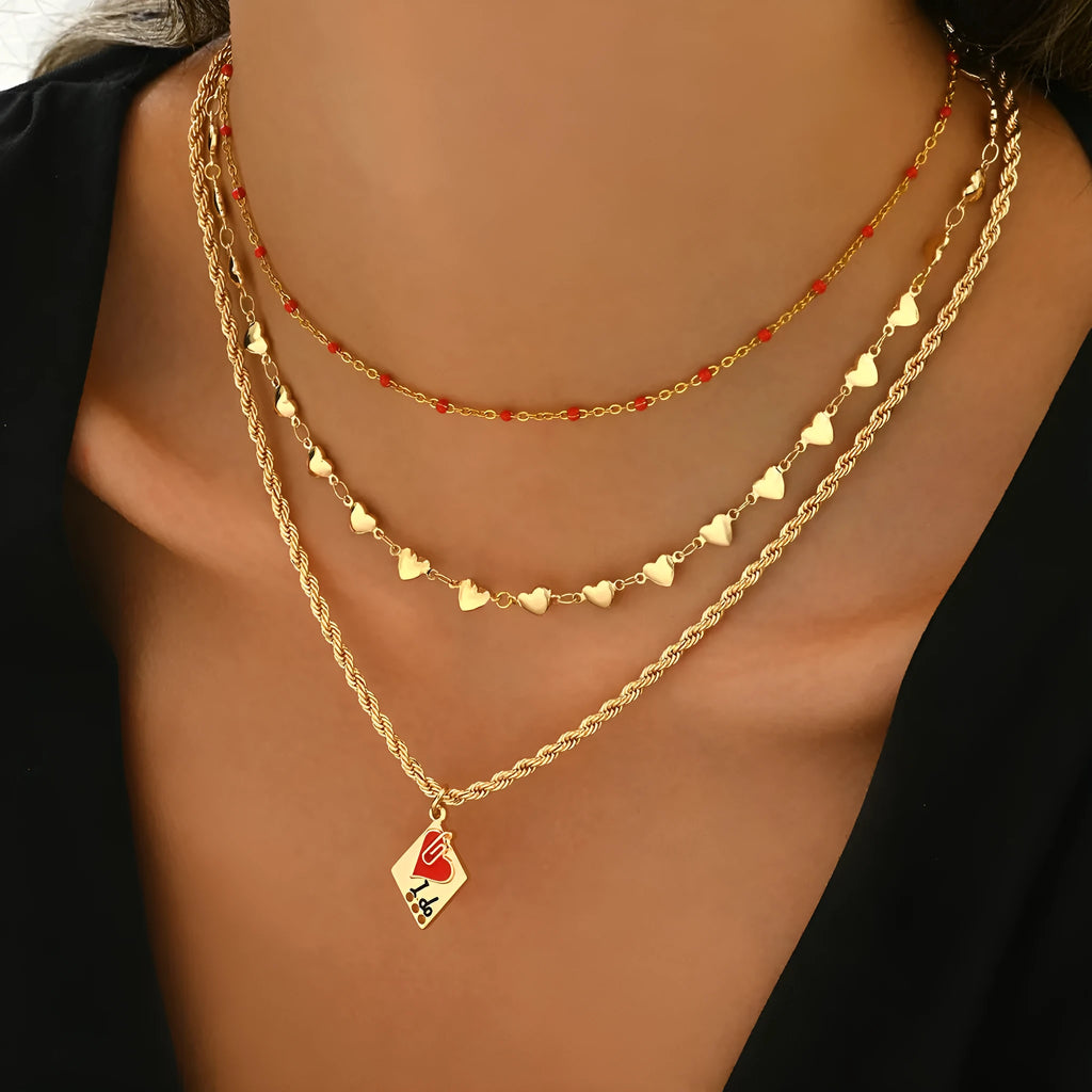 Silver-tone adjustable clavicle chain necklace with a geometric heart pendant on a three-layer chain.