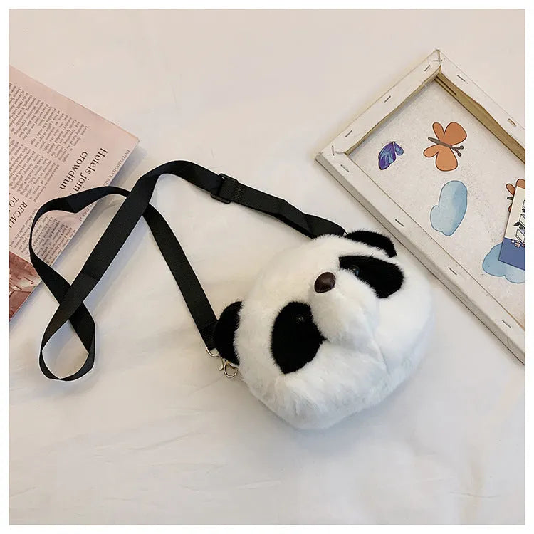 Soft plush crossbody bag with panda head design, cylindrical shape, and sandwich pocket