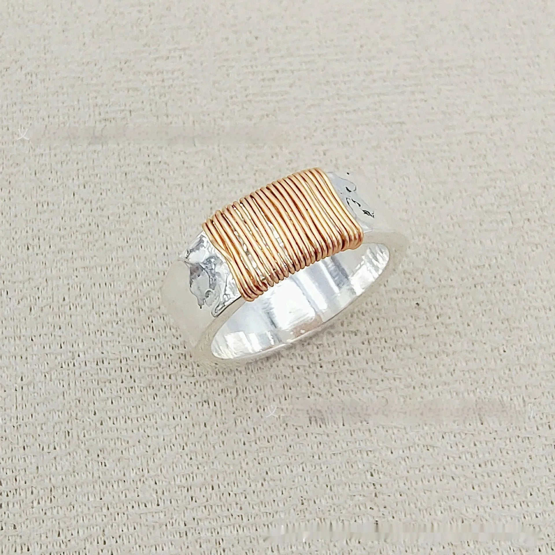 Simple geometric ring bracelet in electroplated copper with silver gold coil finish showing irregular coil design