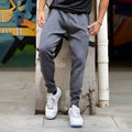 Men's deep gray stretch polyester sweatpants with panel zip pockets, side view