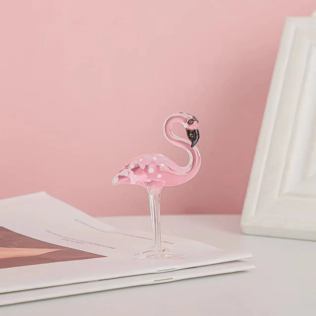 Pink crystal flamingo decorative sculpture on a table, modern simple style.