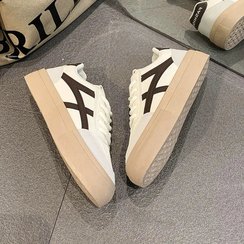 Brown and blue low-top women's casual lace-up shoes with round toe and patent leather finish.