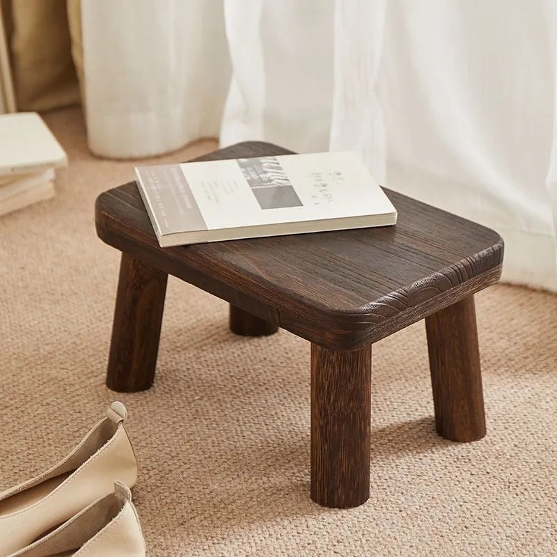 Solid wood household changing stool with a distressed finish and bracket structure.