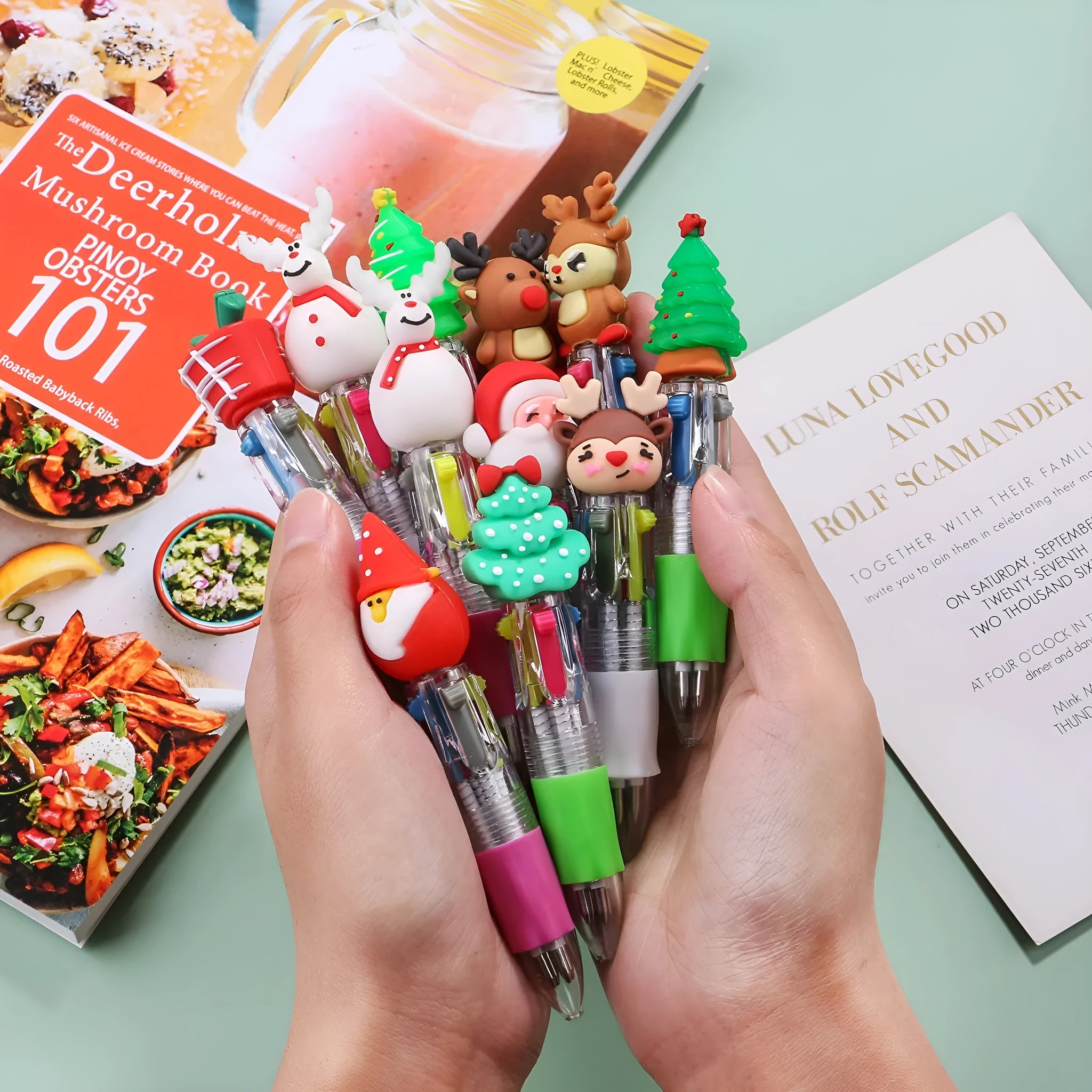 11cm long Christmas-themed four-colour ballpoint pen showing festive designs like reindeer and trees.