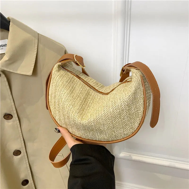 Women's knitted straw woven crossbody bag showing internal phone and file compartments