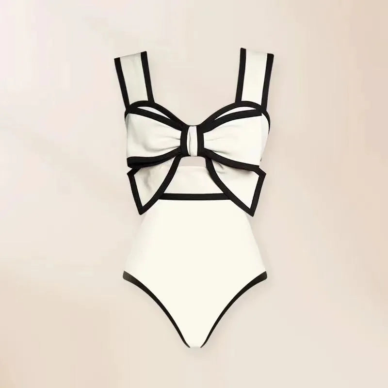 Women's black one-piece swimsuit with white round skirt and bow decoration on front